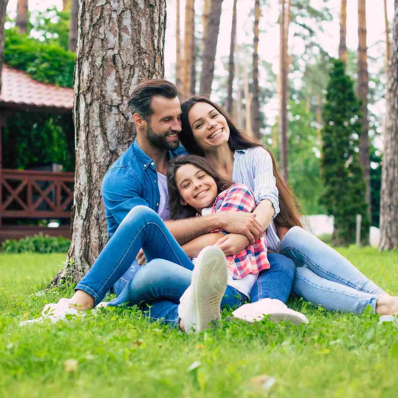 Parents and their daughter relaxing together outdoors