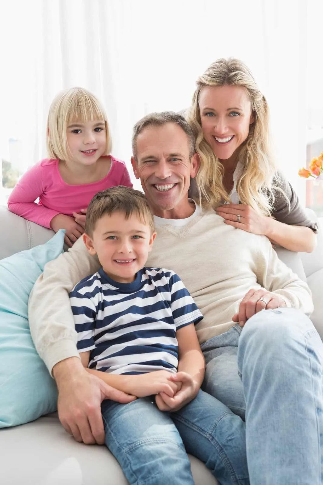 Family smiling together on a sofa